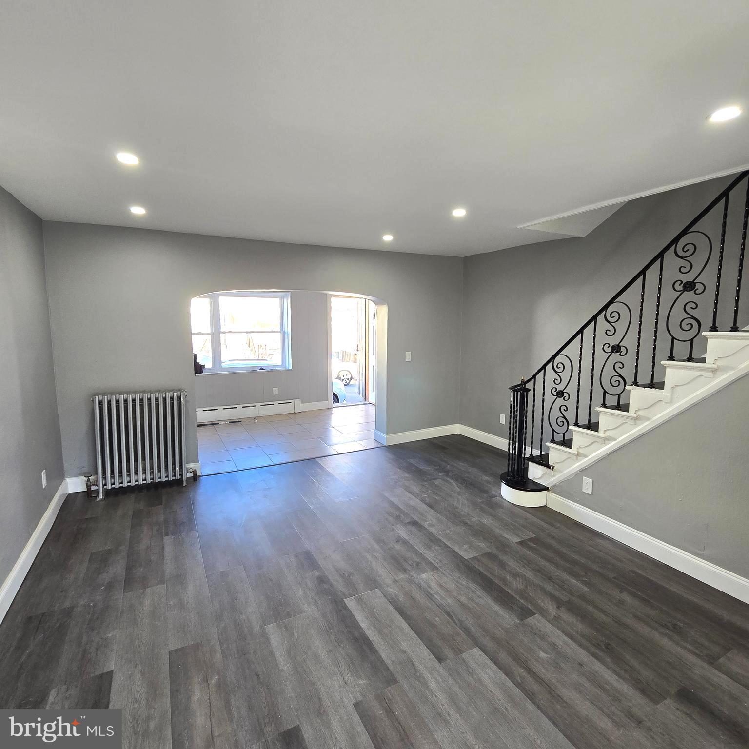 2634 South Daggett Street Philadelphia, PA 19142 - Photo 7 of 28 a view of an empty room with wooden floor and staircase