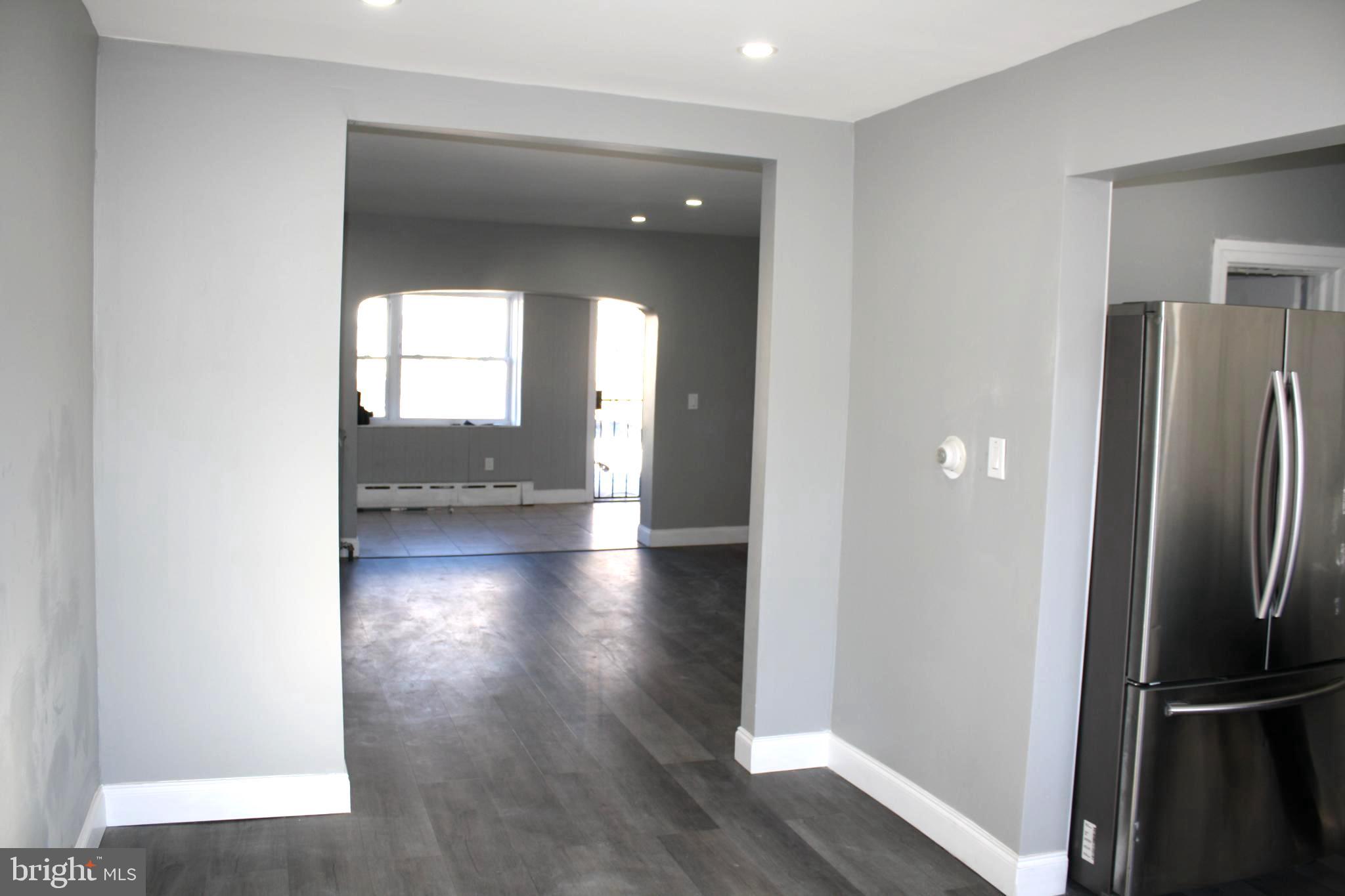2634 South Daggett Street Philadelphia, PA 19142 - Photo 8 of 28 a view of a hallway with wooden floor and a living room