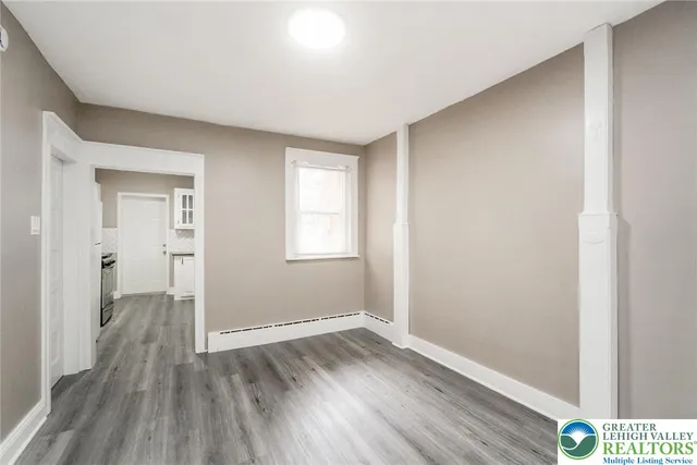 a view of a livingroom with wooden floor and stairs