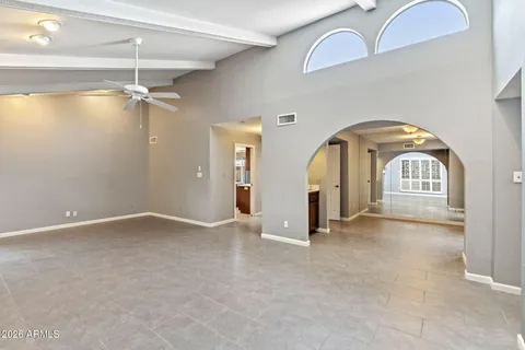 a view of an empty room with a fireplace and a window