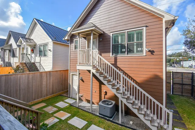 a view of a house with wooden floor roof and wooden fence