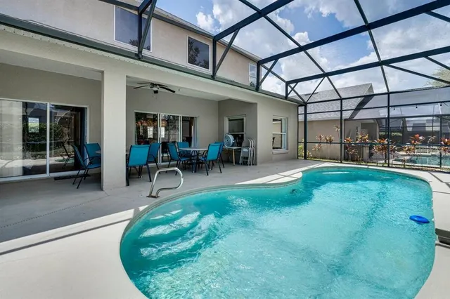 a view of a patio with table and chairs with plants and wooden fence