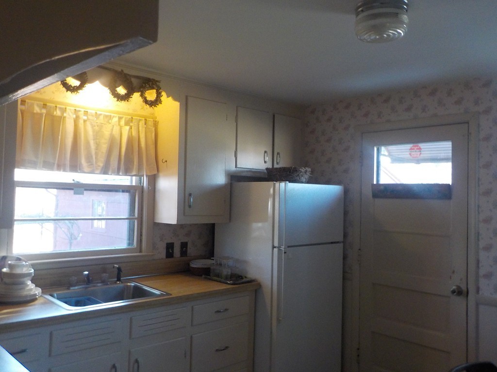 91 Dewitt Street Springfield, MA 01129 - Photo 5 of 15 a kitchen with a refrigerator and sink