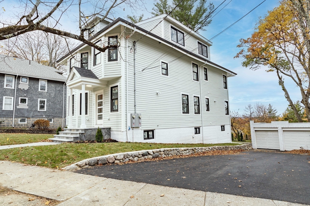 125 Mt Vernon Street, Unit 2 Newton, MA 02465 - Photo 3 of 36 a view of a white house with a large windows