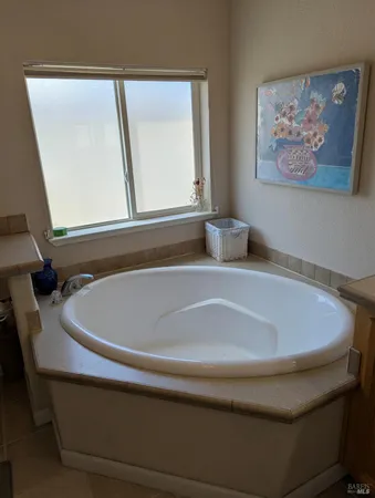 a bathroom with a bathtub and a window
