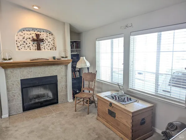 a kitchen with a fireplace and a window