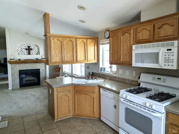 a kitchen with a stove top oven sink and cabinets