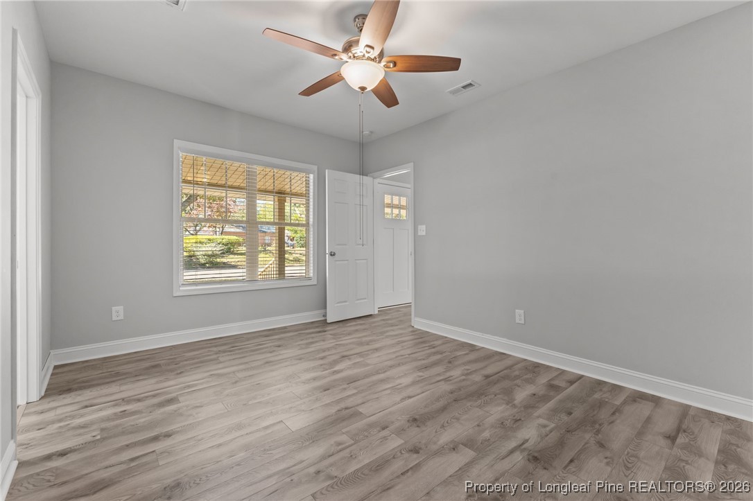 502 North Stewart Street Raeford, NC 28376 - Photo 16 of 48 wooden floor in an empty room with a window
