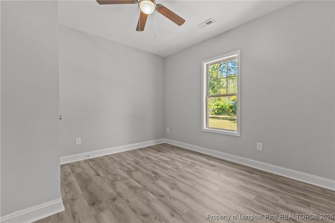 502 North Stewart Street Raeford, NC 28376 - Photo 24 of 48 an empty room with a window and ceiling fan