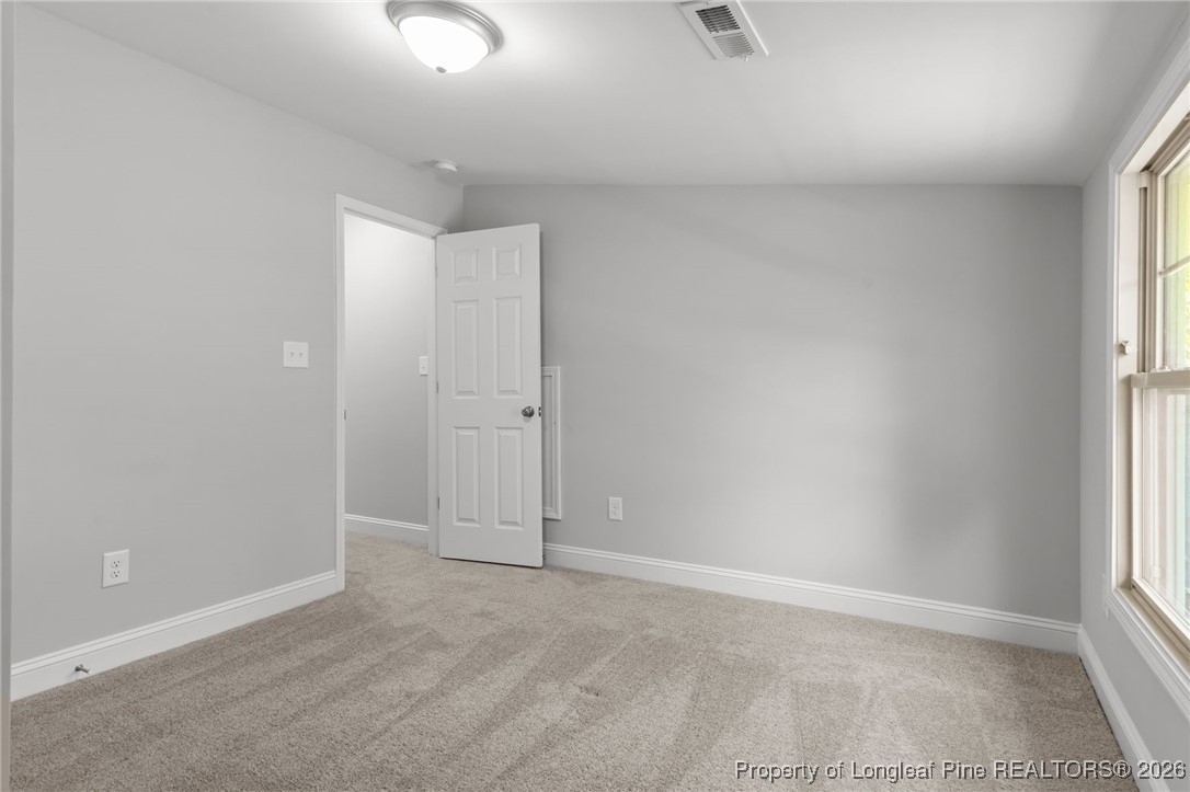 502 North Stewart Street Raeford, NC 28376 - Photo 30 of 48 an empty room with windows and closet