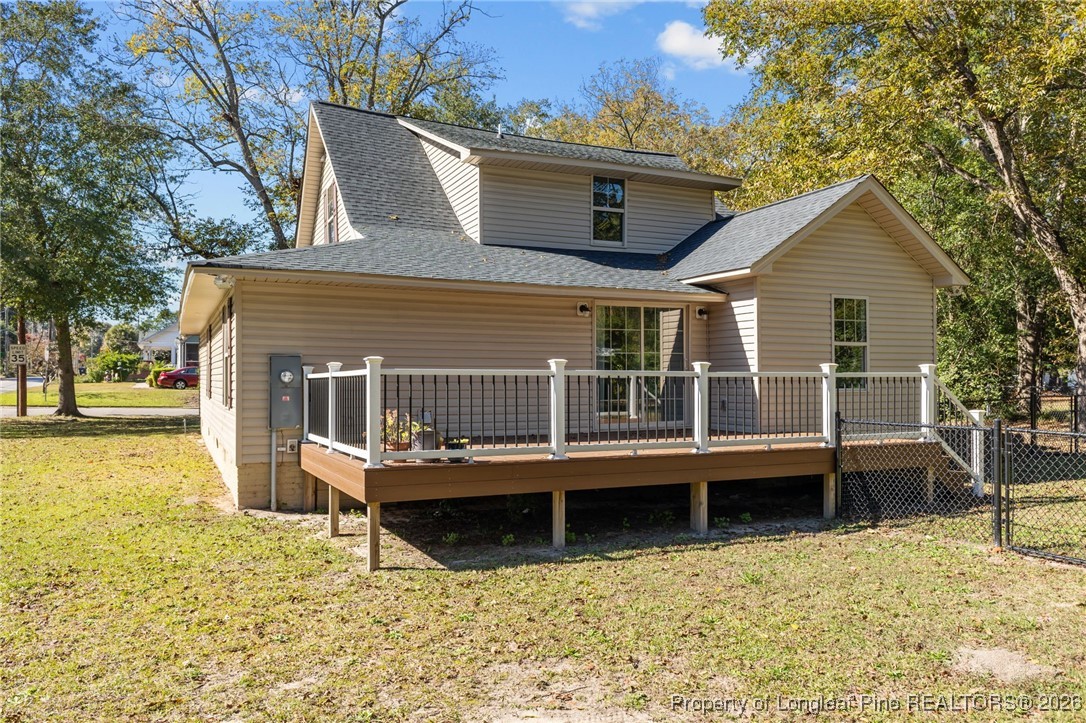 502 North Stewart Street Raeford, NC 28376 - Photo 38 of 48 a view of a house with wooden deck and a large tree