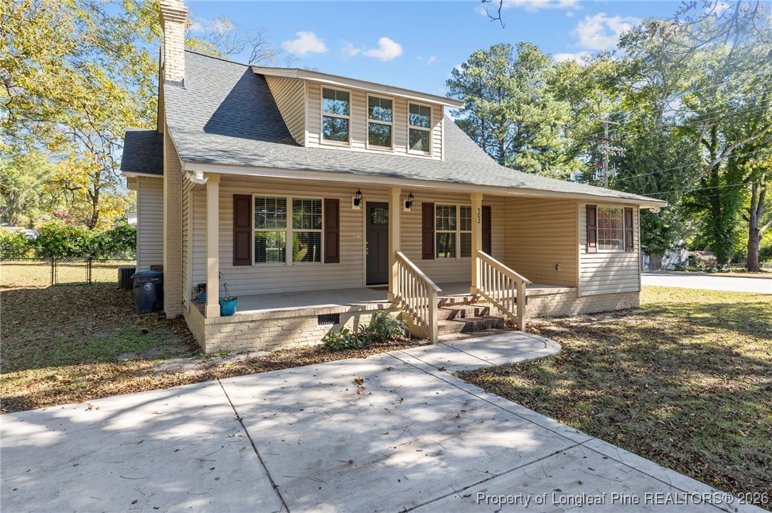 502 North Stewart Street Raeford, NC 28376 - Photo 46 of 48 a front view of a house with a yard and garage
