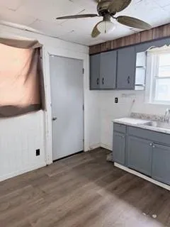 a kitchen with a sink window and cabinets