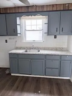 a bathroom with a sink vanity granite and a mirror