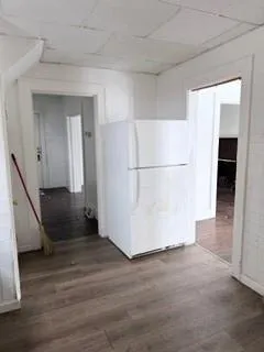 a view of a refrigerator in kitchen and wooden floor