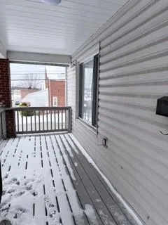 a view of a balcony with wooden floor
