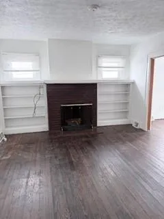 a room with a fireplace and a dresser
