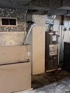 a view of a backyard with a large window and wooden fence