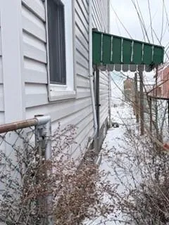a side view of a house with a window