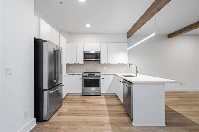 a kitchen with a refrigerator stove and sink
