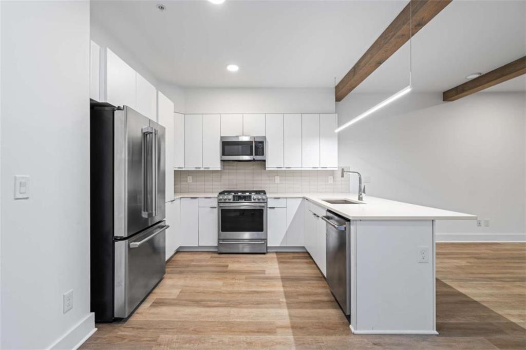 346 Peters Street Southwest, Unit 206 Atlanta, GA 30313 - Photo 3 of 19 a kitchen with a refrigerator stove and sink