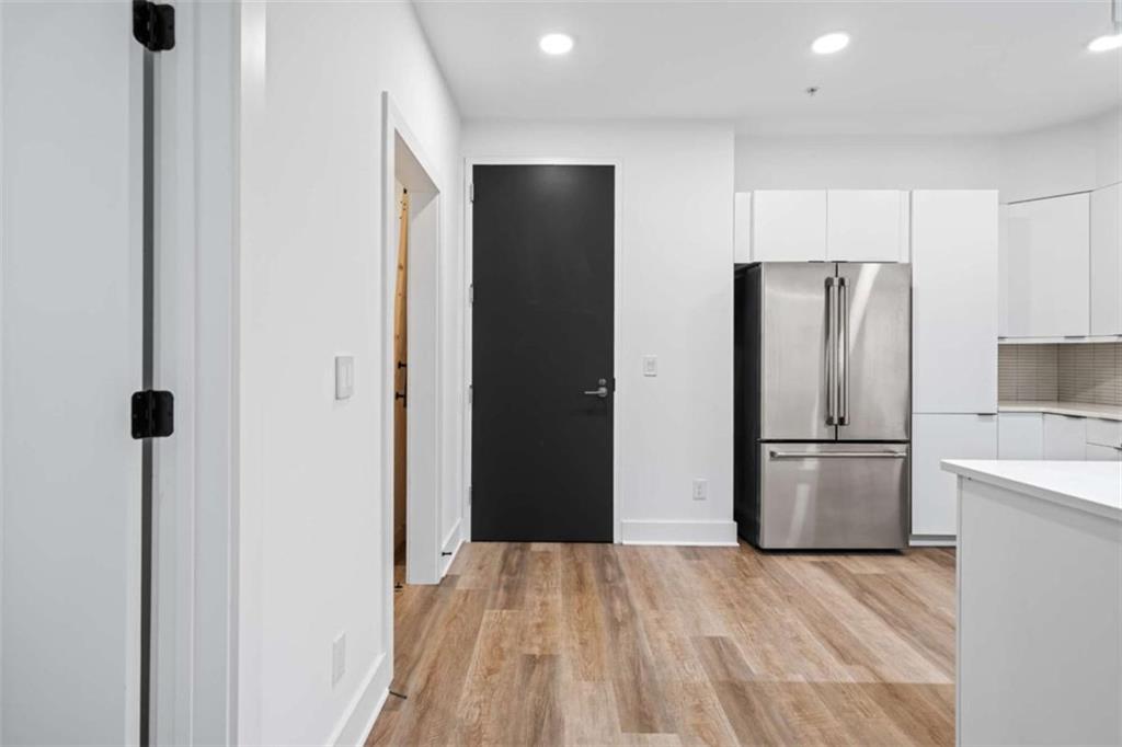 346 Peters Street Southwest, Unit 206 Atlanta, GA 30313 - Photo 5 of 19 a kitchen with a refrigerator and a sink