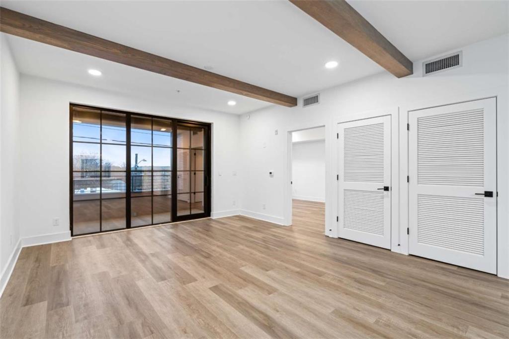 346 Peters Street Southwest, Unit 206 Atlanta, GA 30313 - Photo 6 of 19 a view of empty room with wooden floor and fan