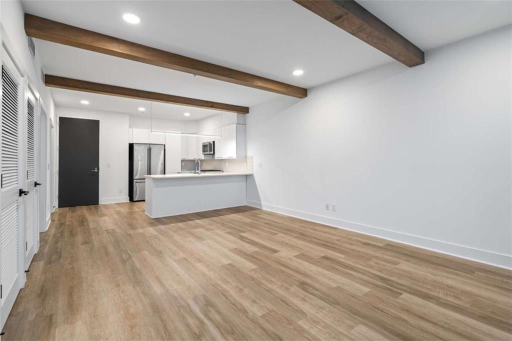 346 Peters Street Southwest, Unit 206 Atlanta, GA 30313 - Photo 7 of 19 a view of a kitchen with a sink and a stove top oven
