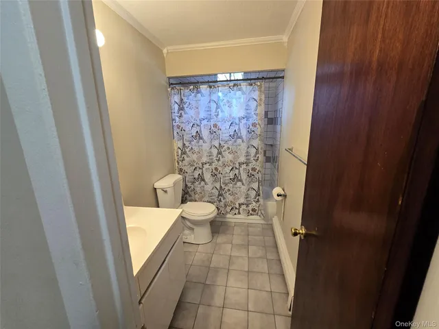 a bathroom with a granite countertop window a toilet and a shower