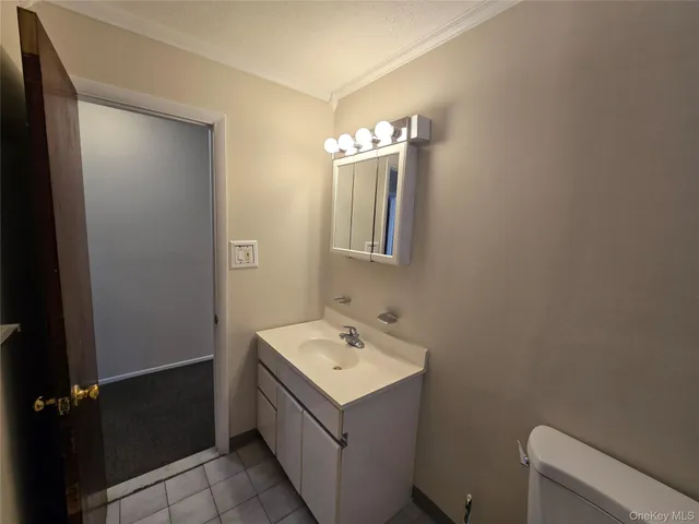 a bathroom with a sink toilet and mirror