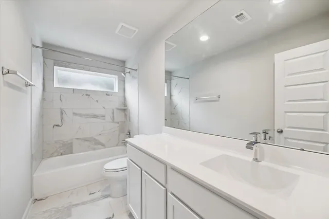 a bathroom with a sink a toilet and bathtub