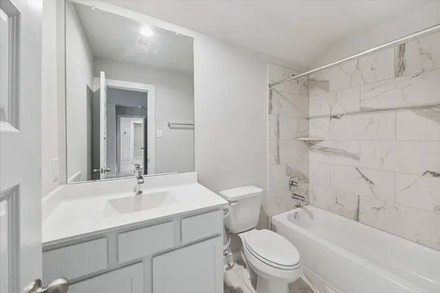 a bathroom with a sink a toilet and a bathtub