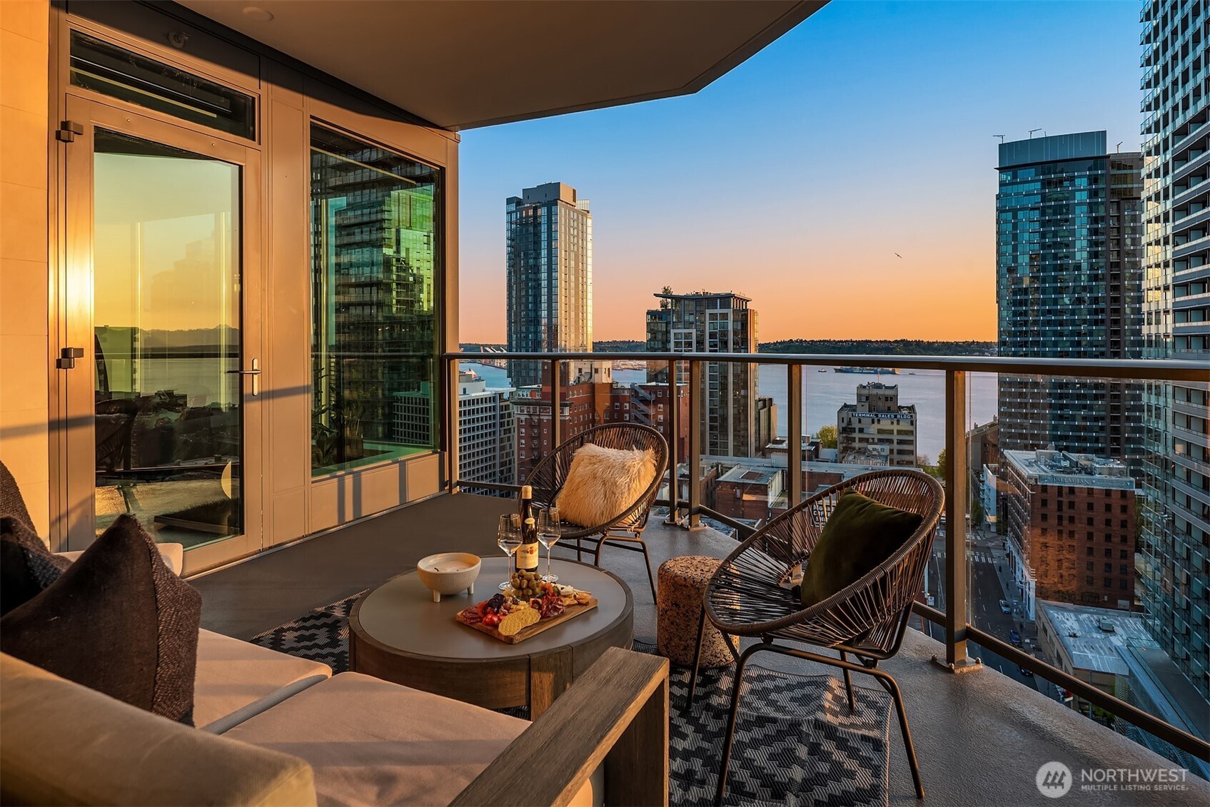 a view of a balcony and dining table with chairs