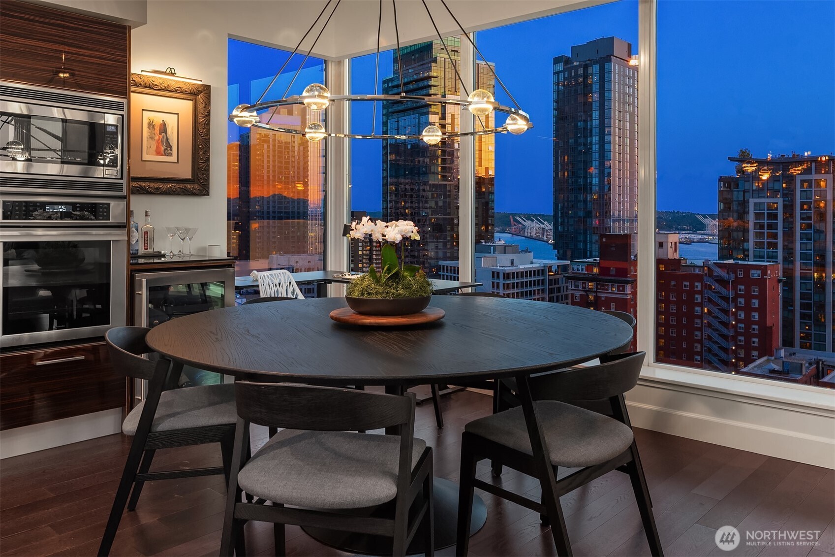 1920 4th Avenue, Unit 2202 Seattle, WA 98101 - Photo 13 of 35 a view of a dining room with furniture and chandelier