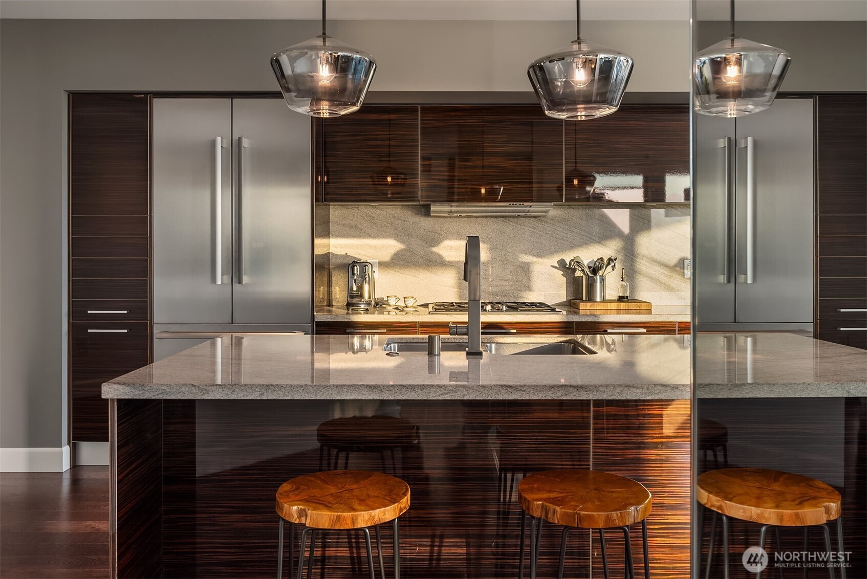 1920 4th Avenue, Unit 2202 Seattle, WA 98101 - Photo 16 of 35 a kitchen with kitchen island granite countertop wooden floor and stainless steel appliances