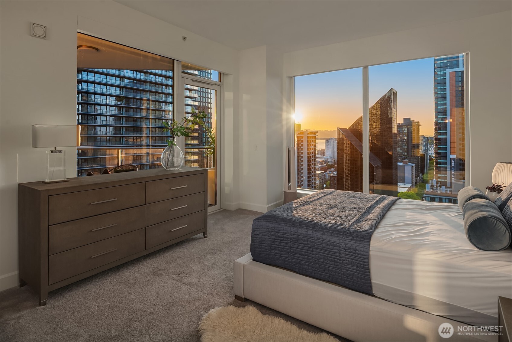 1920 4th Avenue, Unit 2202 Seattle, WA 98101 - Photo 19 of 35 a bedroom with a bed and a dresser