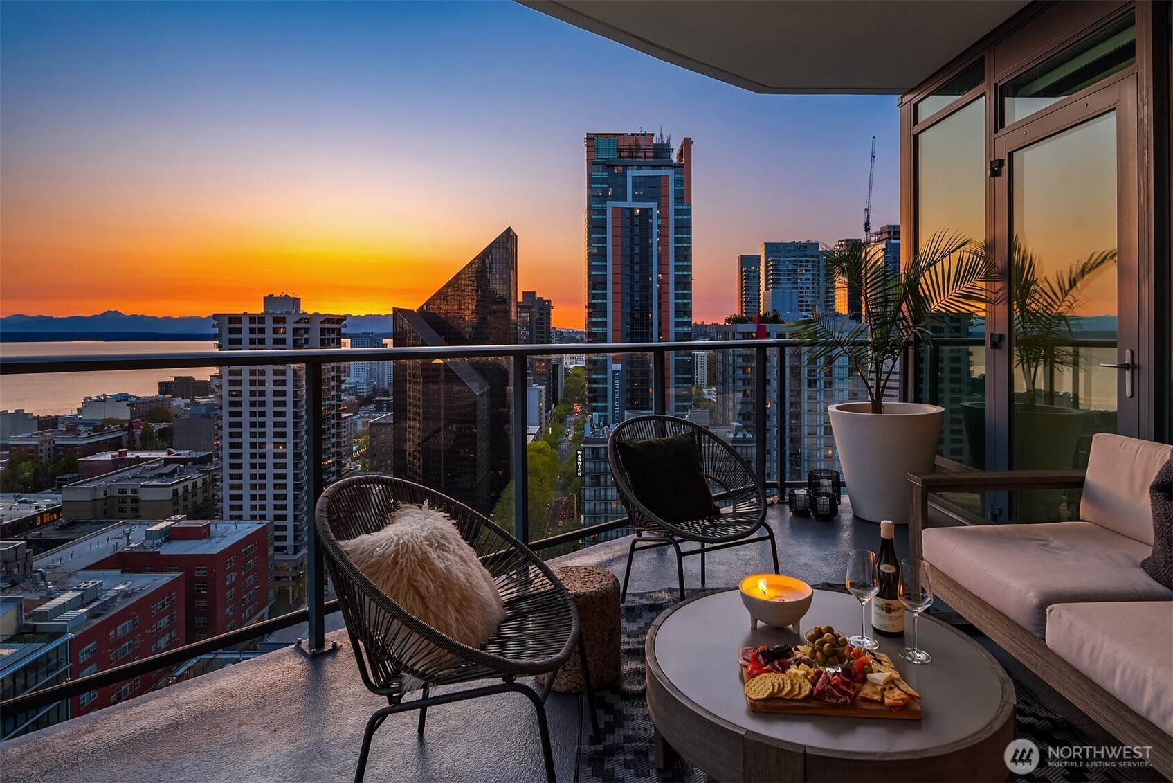 1920 4th Avenue, Unit 2202 Seattle, WA 98101 - Photo 21 of 35 a balcony with table and chairs