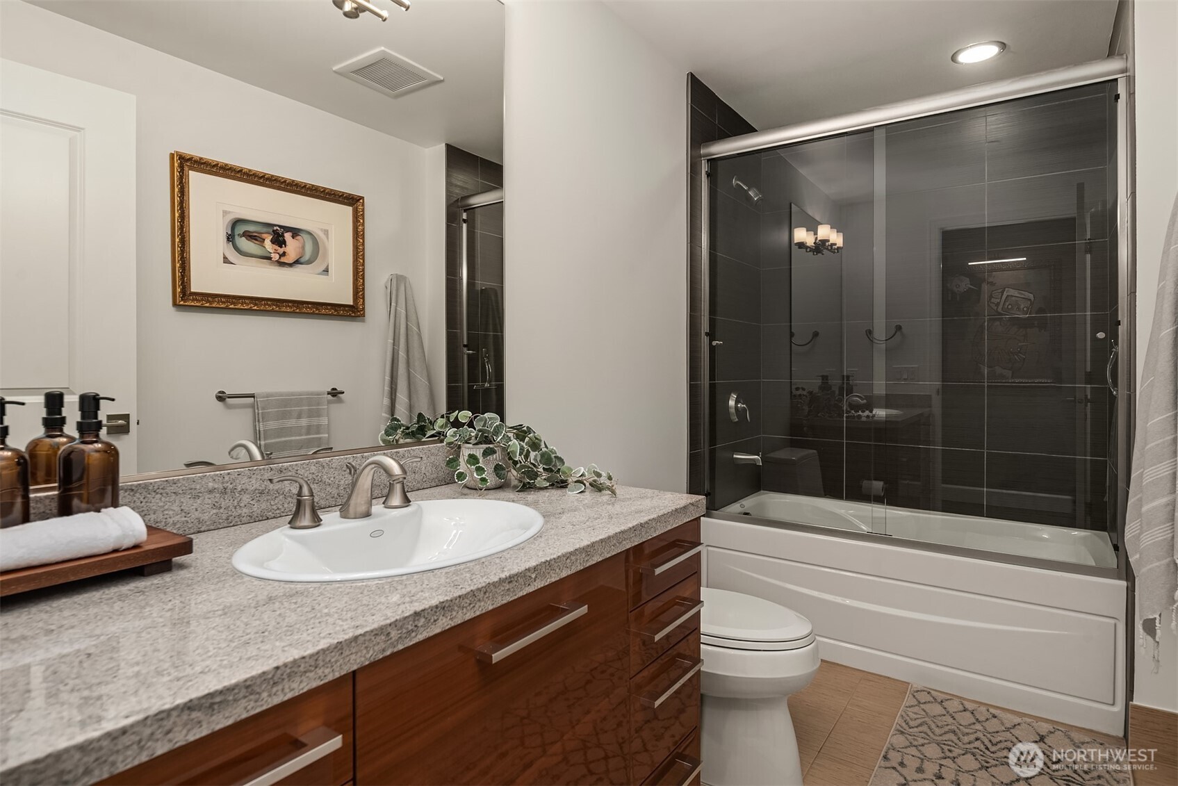 1920 4th Avenue, Unit 2202 Seattle, WA 98101 - Photo 27 of 35 a bathroom with a sink a toilet and shower