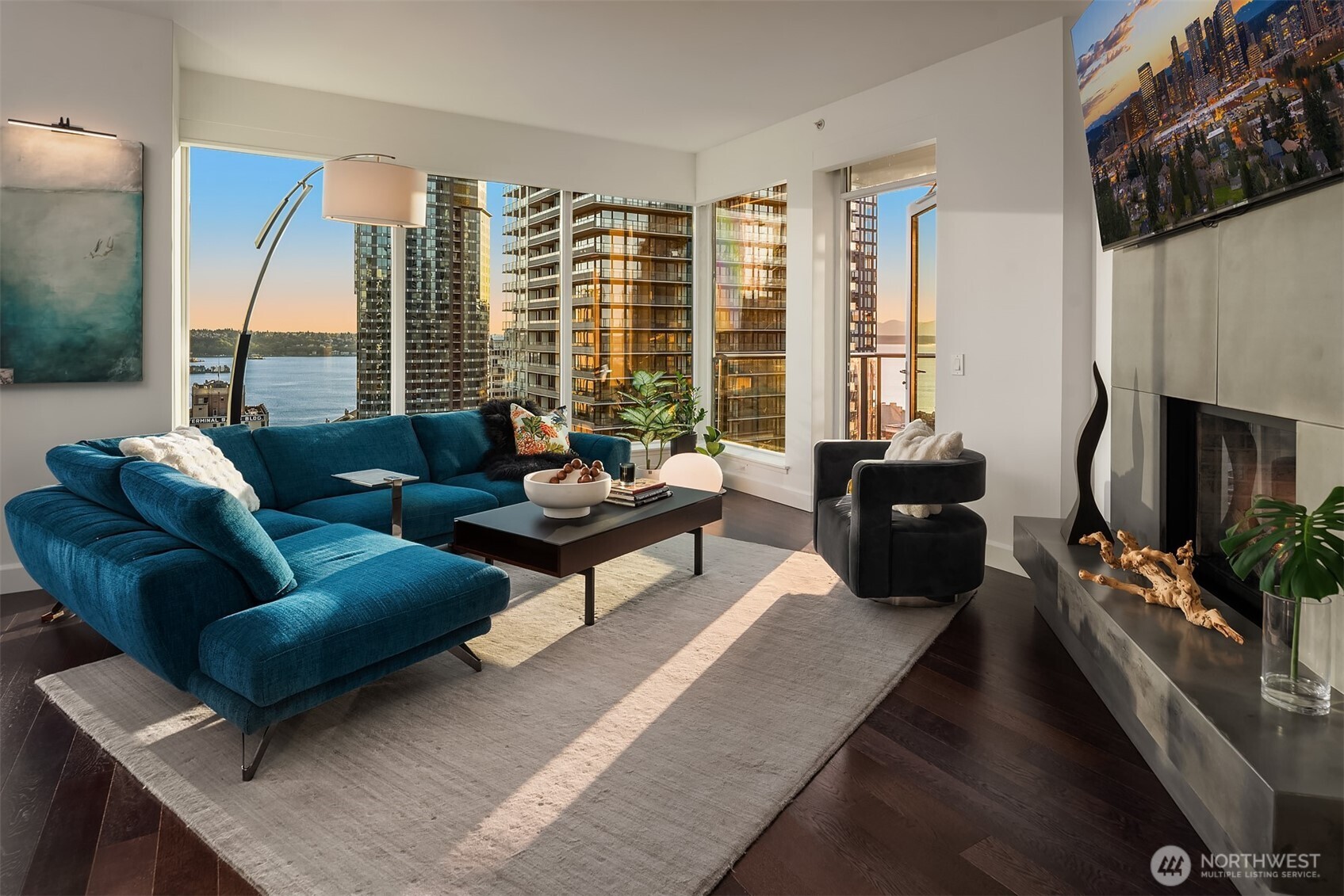 1920 4th Avenue, Unit 2202 Seattle, WA 98101 - Photo 8 of 35 a living room with furniture wooden floor and a flat screen tv