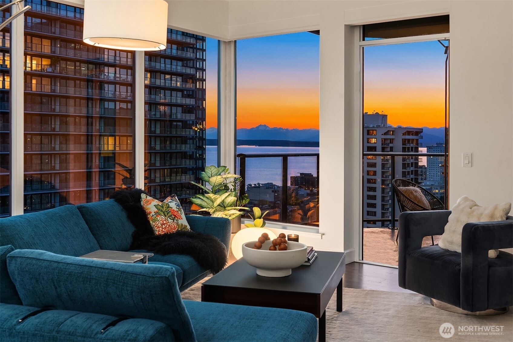 1920 4th Avenue, Unit 2202 Seattle, WA 98101 - Photo 9 of 35 a view of a patio with couches and a potted plant on a table