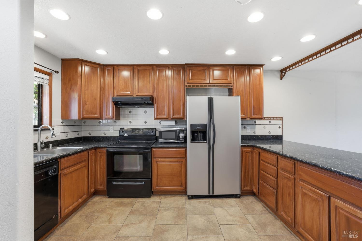 900 Southampton Road, Unit 169 Benicia, CA 94510 - Photo 5 of 21 a kitchen with stainless steel appliances granite countertop a refrigerator a stove and a sink