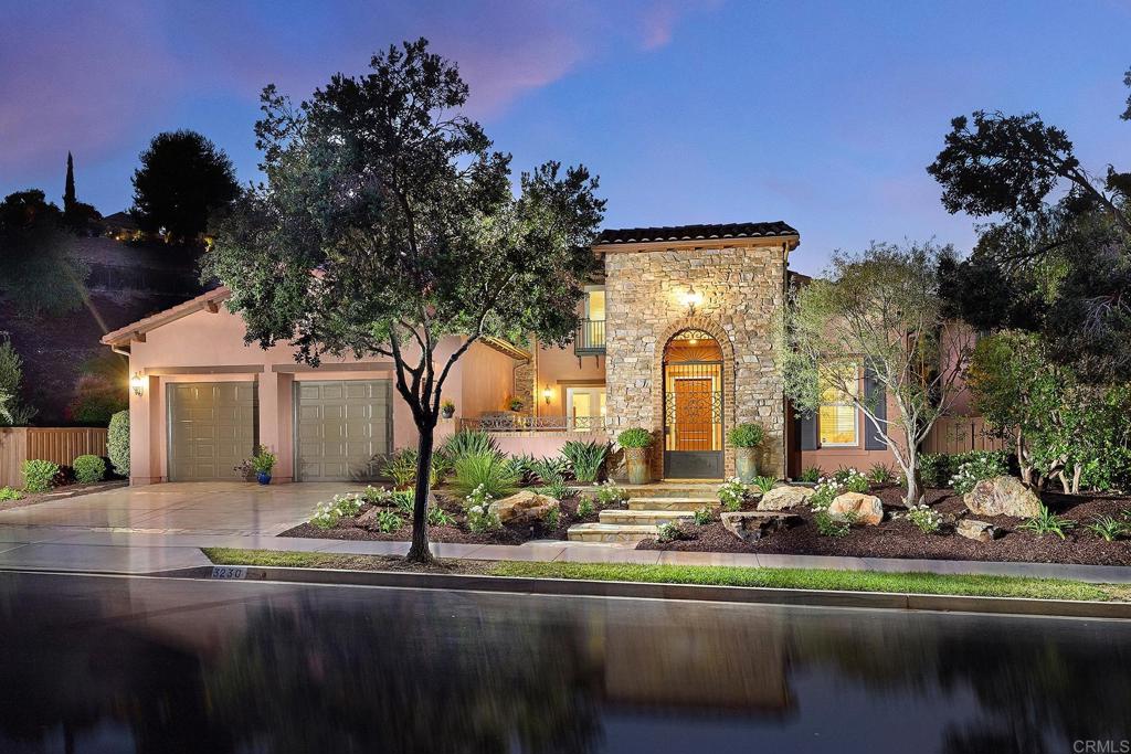 3230 Corte Aliso Carlsbad, CA 92009 - Photo 1 of 23 a front view of a house with a garden and a tree
