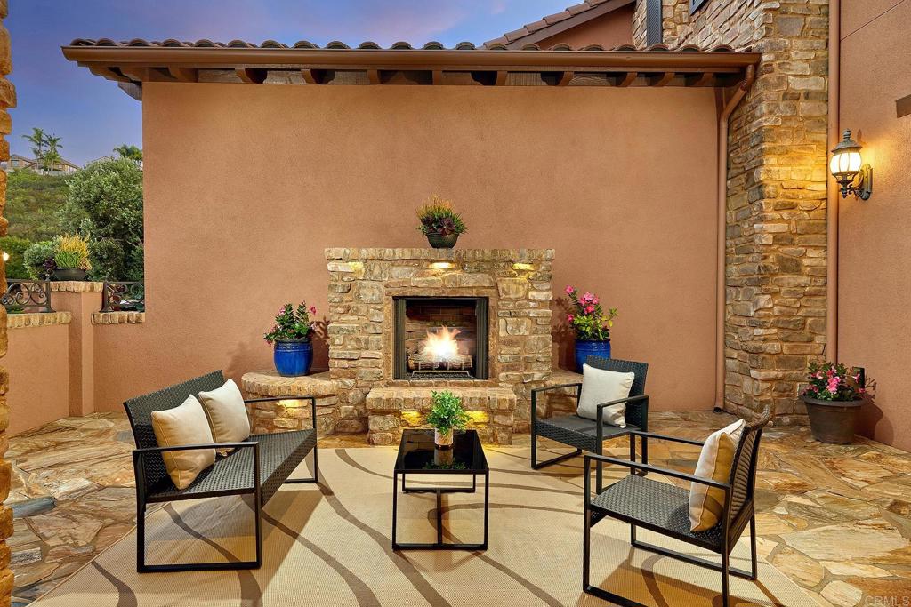 3230 Corte Aliso Carlsbad, CA 92009 - Photo 2 of 23 a view of a patio with table and chairs and potted plants