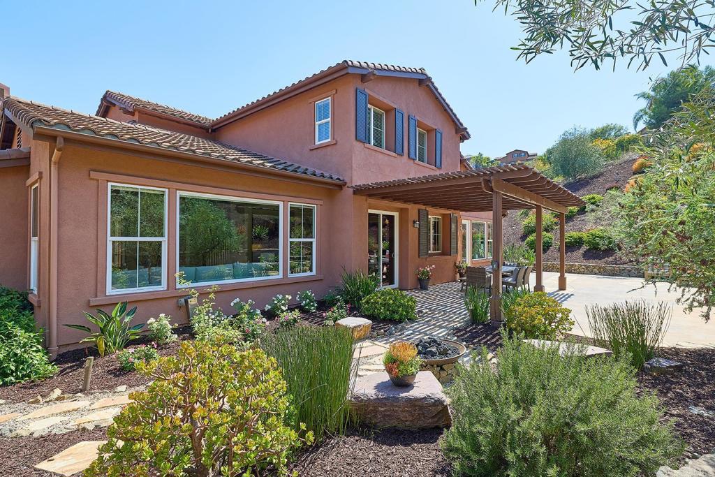 3230 Corte Aliso Carlsbad, CA 92009 - Photo 21 of 23 a front view of a house with a yard and potted plants