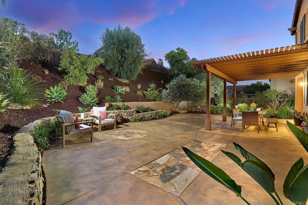 3230 Corte Aliso Carlsbad, CA 92009 - Photo 4 of 23 a view of a patio with table and chairs and potted plants