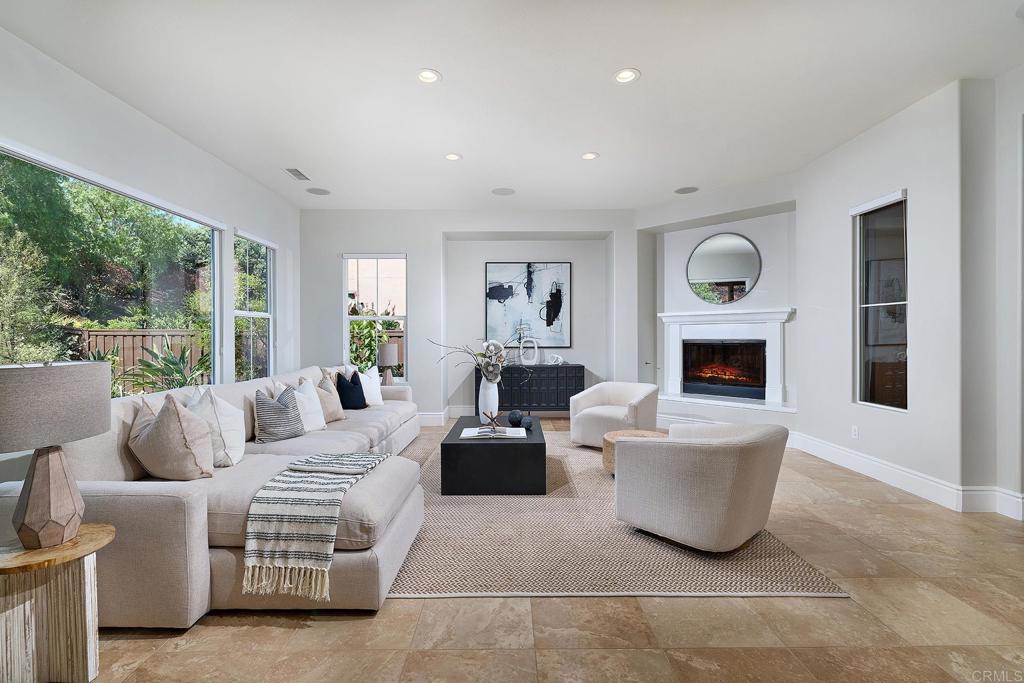 3230 Corte Aliso Carlsbad, CA 92009 - Photo 6 of 23 a living room with furniture a large window and a fireplace