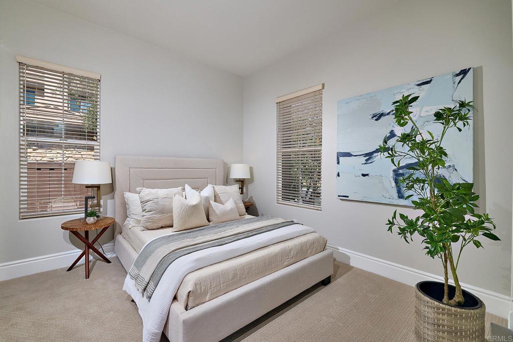 3230 Corte Aliso Carlsbad, CA 92009 - Photo 10 of 23 a bedroom with a large bed and a potted plant