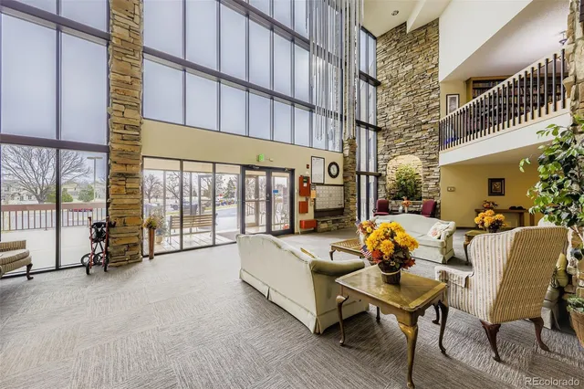 a living room with furniture and a floor to ceiling window