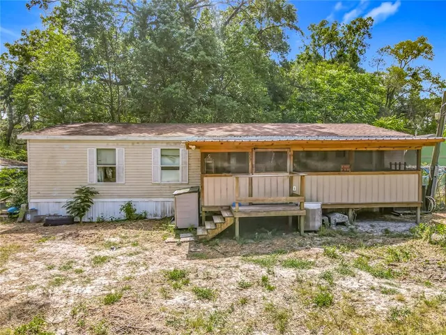 a backyard of a house with yard and outdoor seating