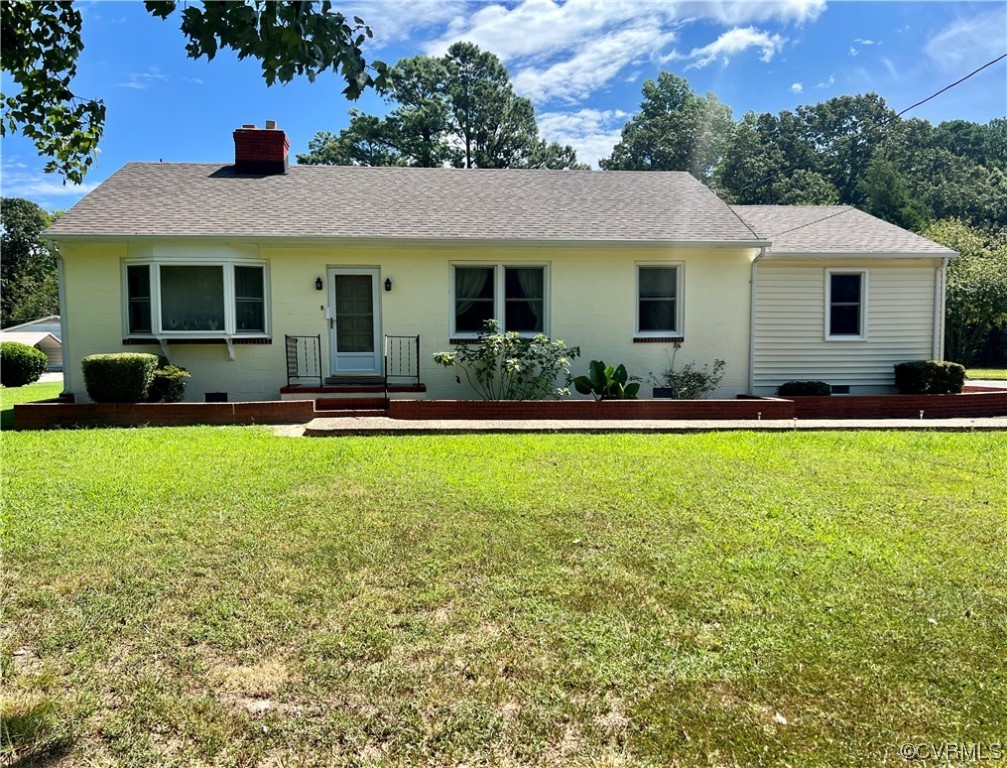 a front view of a house with a yard table and chairs